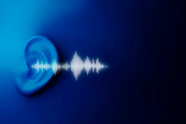 Ear listening to a call echo sound wave on a blue background.